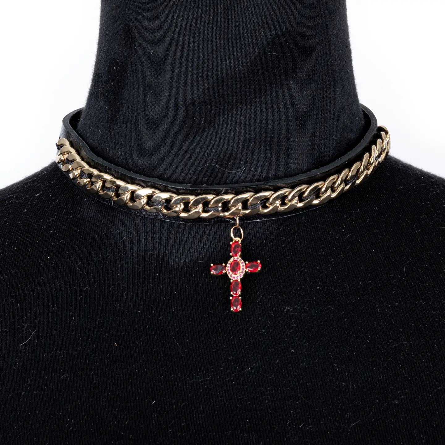 Black leather choker with gold chain detail and a red crystal cross pendant, centered on a white background.