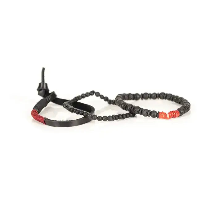 Black multi-layer men’s bracelet set featuring lava stone beads, matte black onyx, layered black strands, and bold red accent beads on a light background.