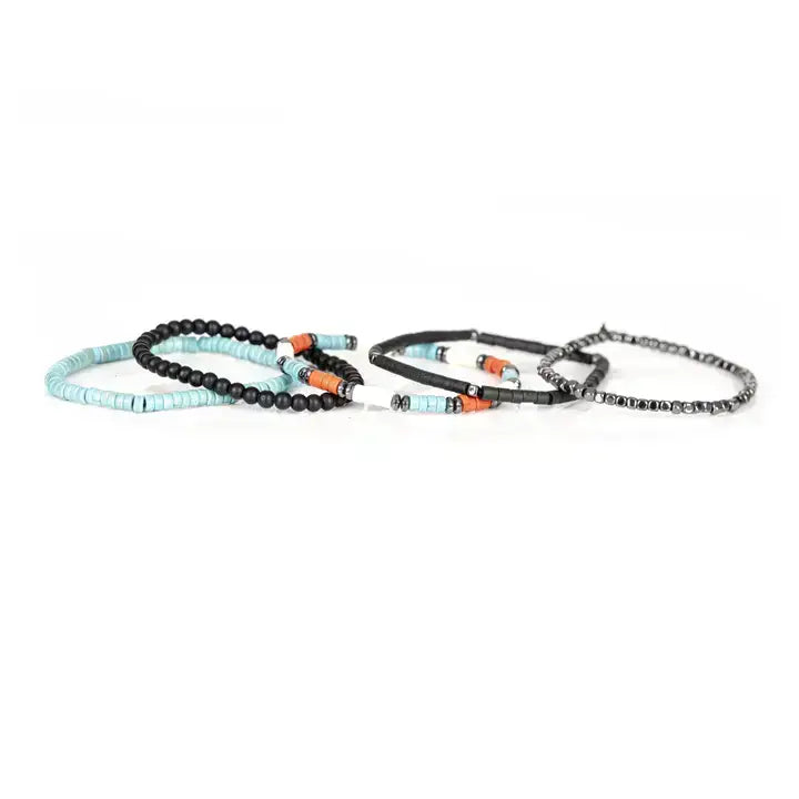 Black multi-layer men’s bracelet featuring hematite cube bead strands, matte black onyx beads, turquoise disc beads, and orange accent details on a light background.
