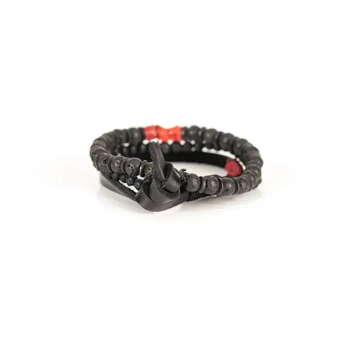Black multi-layer men’s bracelet set featuring lava stone beads, matte black onyx, layered black strands, and bold red accent beads on a light background.