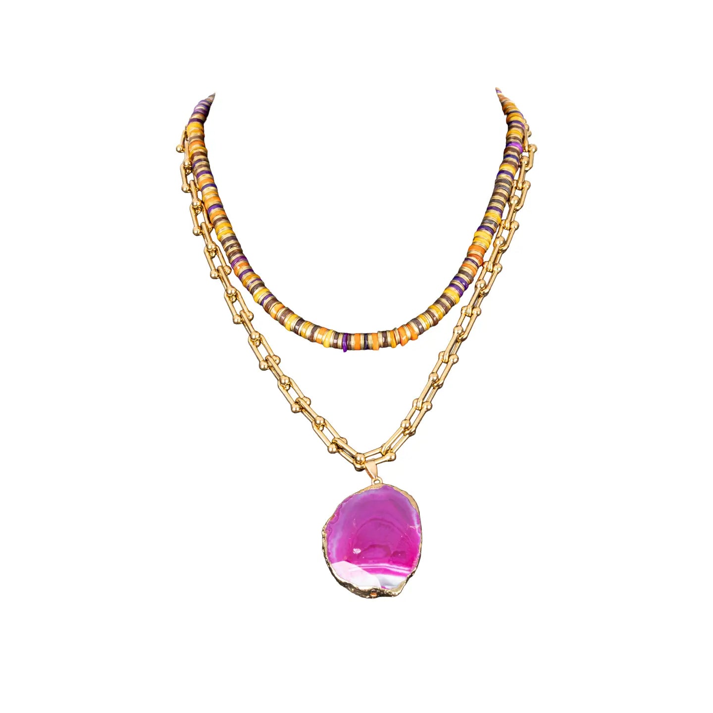 Layered necklace with multicolor beads and pink agate pendant on gold chain on white background.