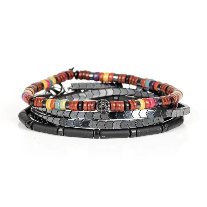 Multicolor multi-layer men’s bracelet featuring colorful disc beads, metallic hematite chevron strands, matte black tubular beads, and crystal centerpiece accent on a light background.