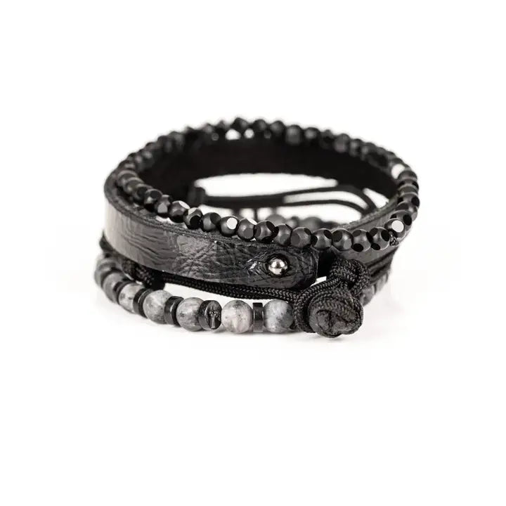 Black multi-layer men’s bracelet featuring faceted black onyx beads, textured black leather band, braided rope layers, marble grey natural stone beads, and metallic spacer accents on a light background.
