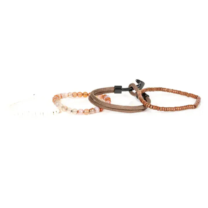 Men’s layered bracelet set featuring brown braided cord, brown heishi beads, polished black metal accents, warm-toned natural stone beads, and white heishi beads, stacked in a refined earthy luxury design on a white background.