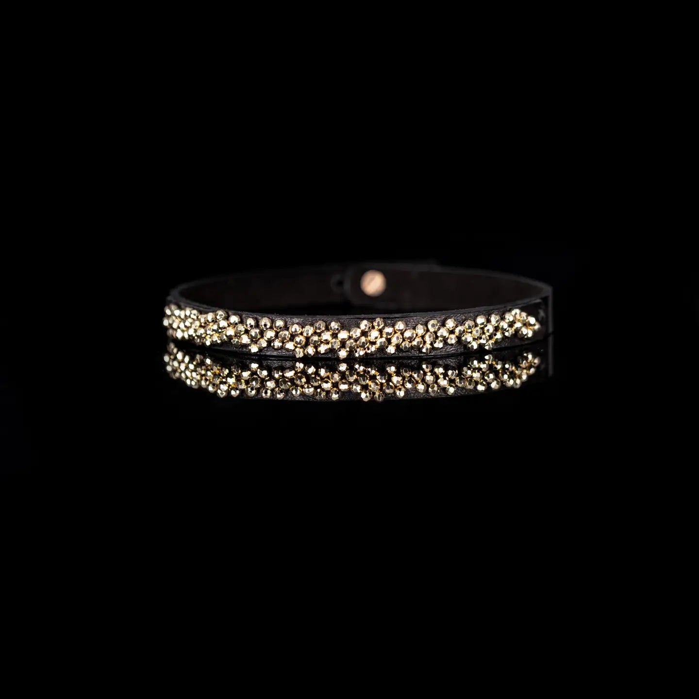 Black leather choker with dense gold beaded detailing across the front, displayed on a white background.