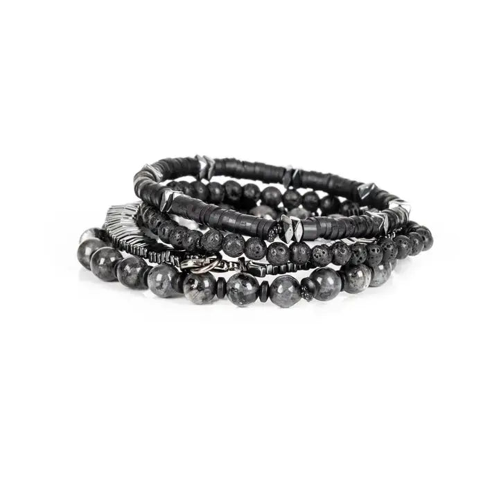 Black and silver multi-layer men’s bracelet featuring lava stone beads, hematite disc strands, silver chevron metal detail, pyramid-cut metallic accents, and marble grey natural stone beads on a light background.