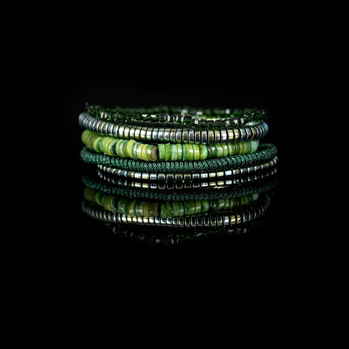 Green multi-layer men’s bracelet set featuring natural green stone disc beads, metallic hematite strands, faceted green crystal beads, and braided green rope on a light background.