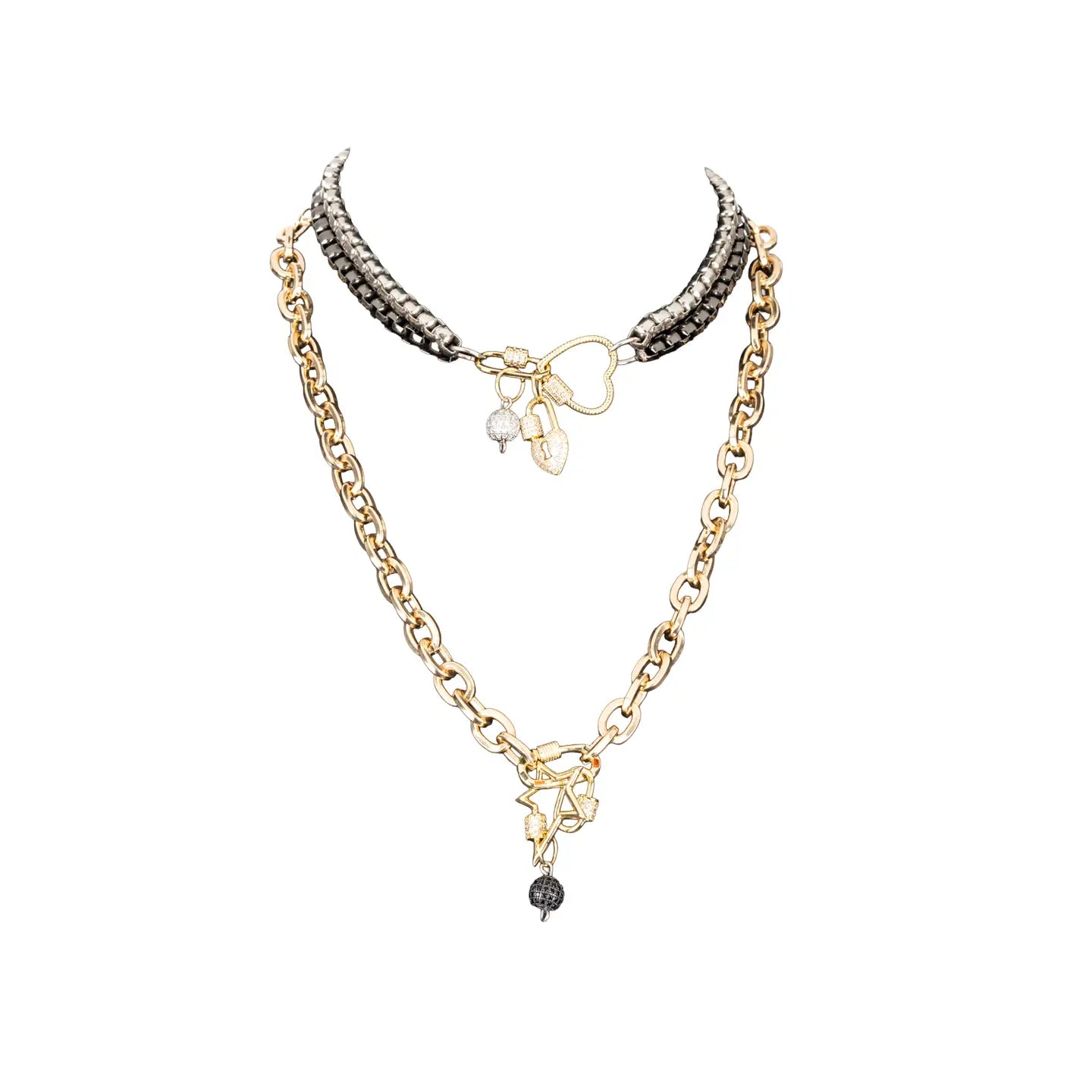 Mixed metal necklace with heart connector, charm details, and drop chain in gold and gunmetal tones on white background.