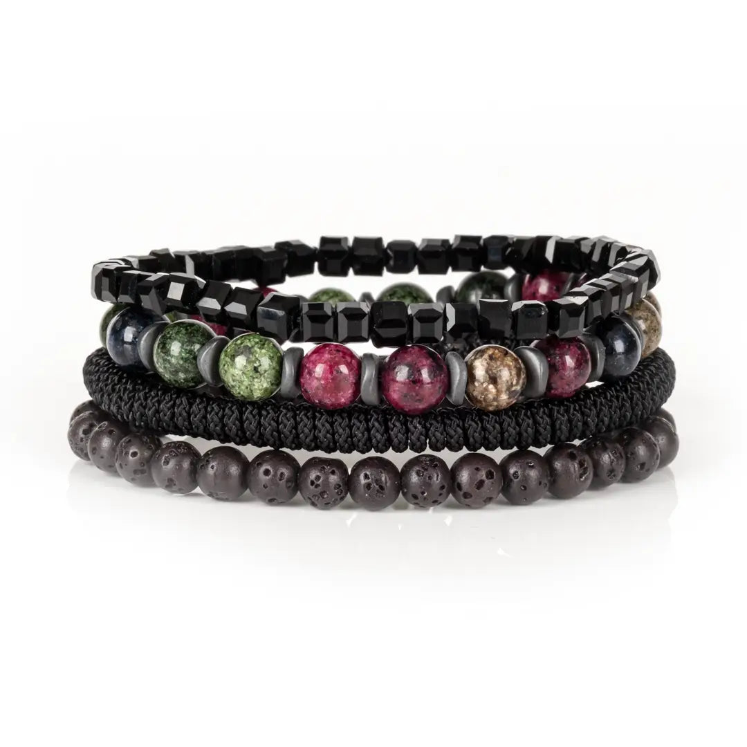 Men's layered bracelet set featuring faceted black crystal cube beads, multicolor natural gemstone beads in green, burgundy, navy, and beige tones, black woven cord detailing, and matte black lava stone beads arranged in a stacked design on a white background.