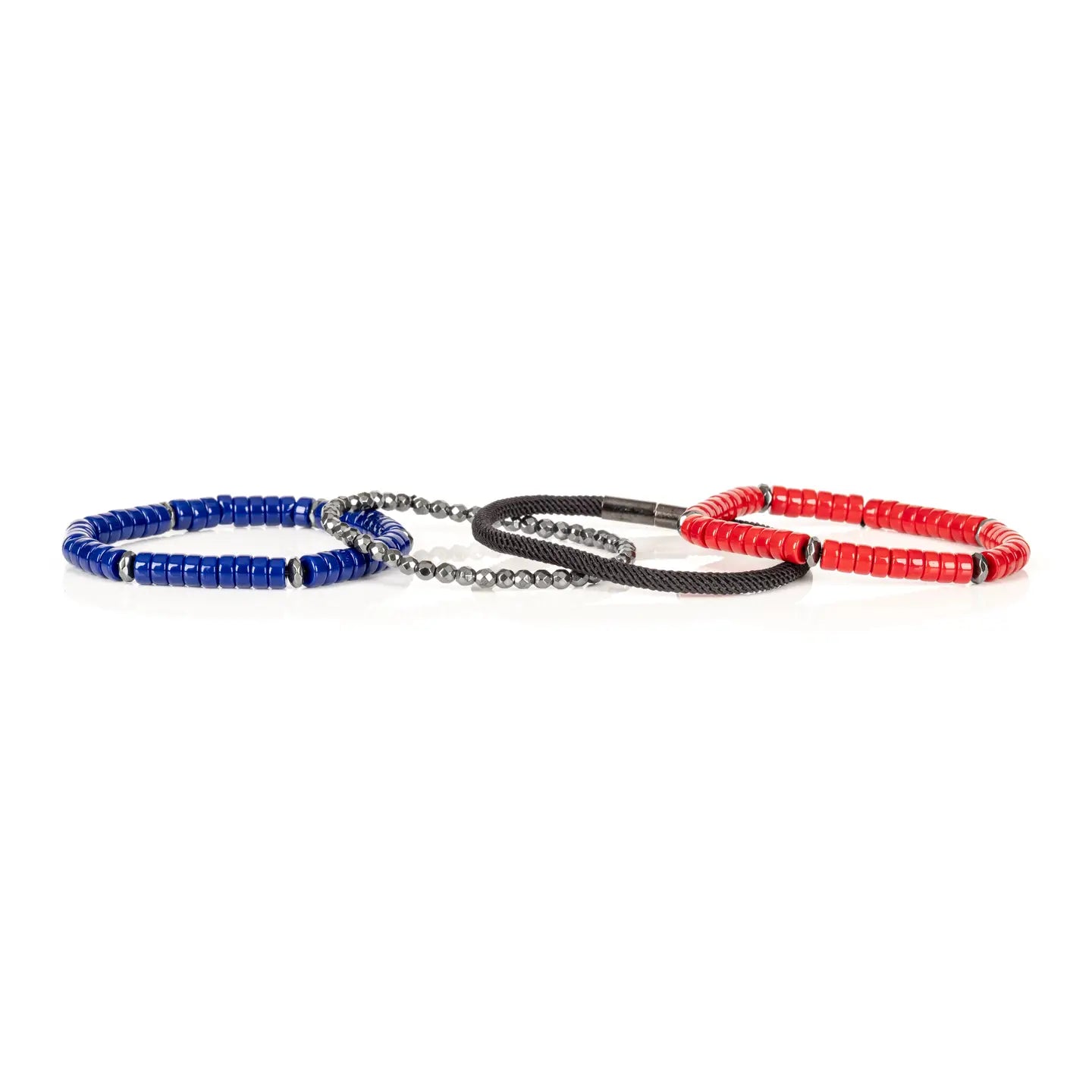 Men’s layered bracelet set featuring vibrant red and royal blue heishi beads, black braided cord, faceted hematite crystal beads, and gunmetal spacer accents, stacked in a bold contemporary luxury design on a white background.