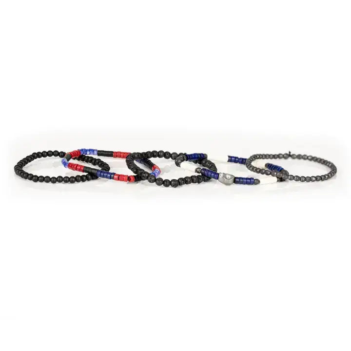 Black multi-layer men’s bracelet featuring lava stone beads, faceted hematite beads, blue cylindrical accents, red and white spacer details, and layered black bead strands on a light background.