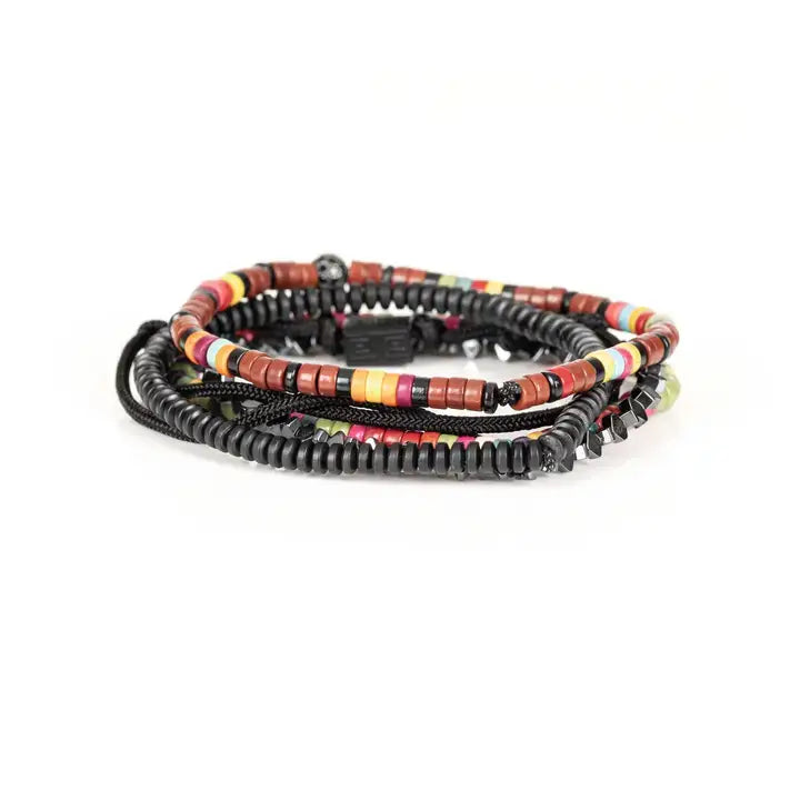 Multicolor multi-layer men’s bracelet featuring colorful disc bead strands, faceted hematite accents, braided black rope layers, and black geometric centerpiece on a light background.