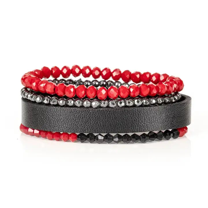 Red and black multi-layer men’s bracelet featuring faceted red crystal beads, hematite bead strands, black leather band, and black faceted stone accents on a light background.
