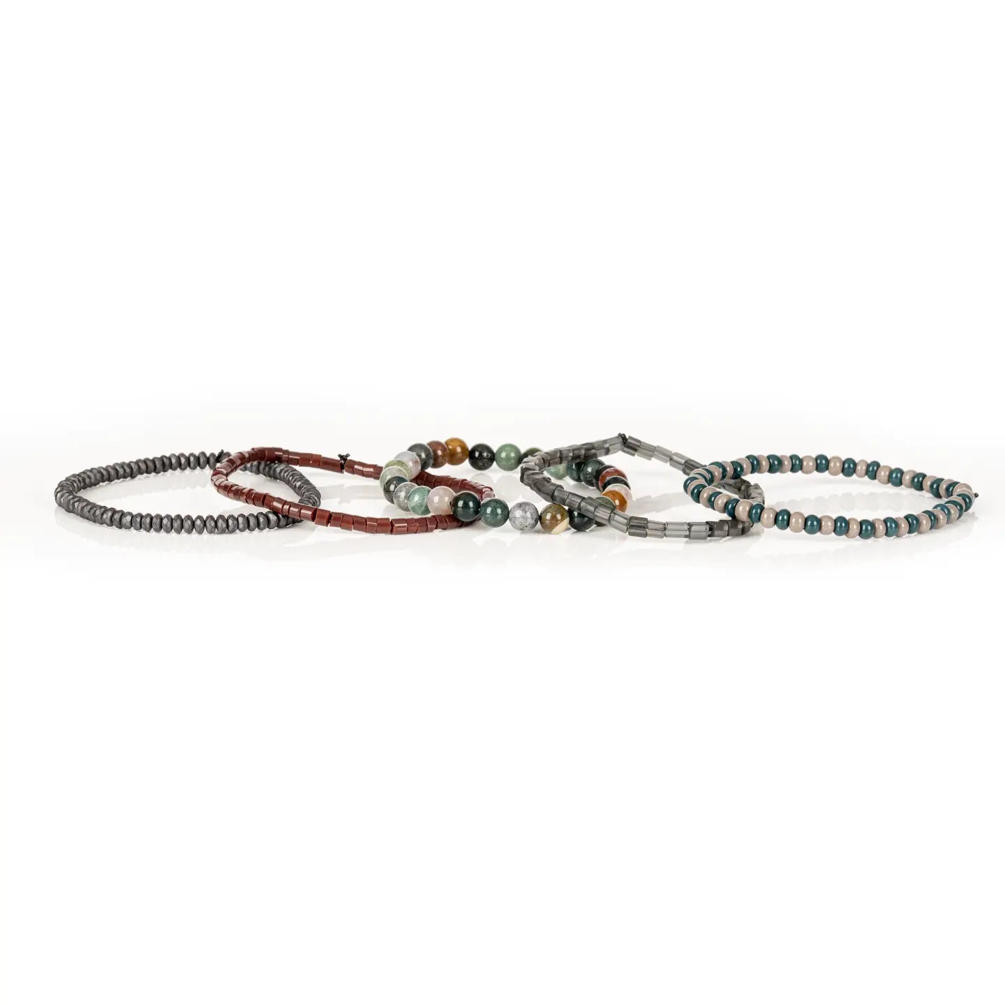 Men’s layered bracelet set featuring teal and beige bead strands, smoky gray translucent beads, multicolor natural stone beads in green, cream, and earth tones, reddish-brown heishi beads, and faceted hematite spacer beads, stacked in a sophisticated earthy luxury design on a white background.