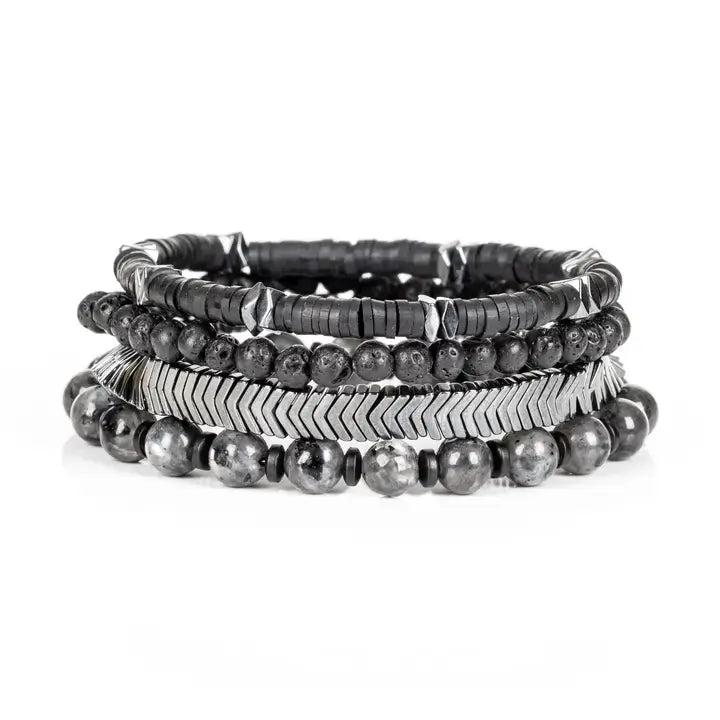 Black and silver multi-layer men’s bracelet featuring lava stone beads, hematite disc strands, silver chevron metal detail, pyramid-cut metallic accents, and marble grey natural stone beads on a light background.