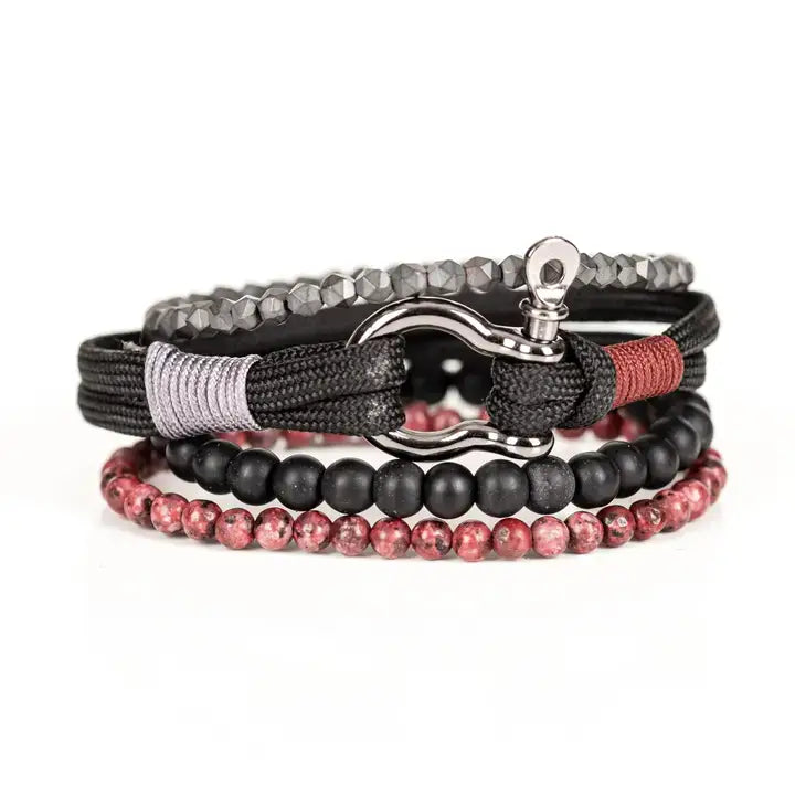 Black and red multi-layer men’s bracelet featuring metallic hook clasp, braided black rope, faceted hematite crystals, matte black beads, and red marbled natural stone beads on a light background.