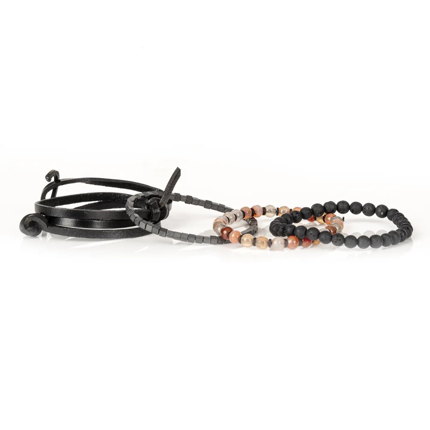 Men's layered bracelet set featuring matte black lava stone beads, faceted brown and cream agate gemstone beads, dark hematite cube beads, and black leather wrap straps arranged in a handcrafted stacked design on a white background.