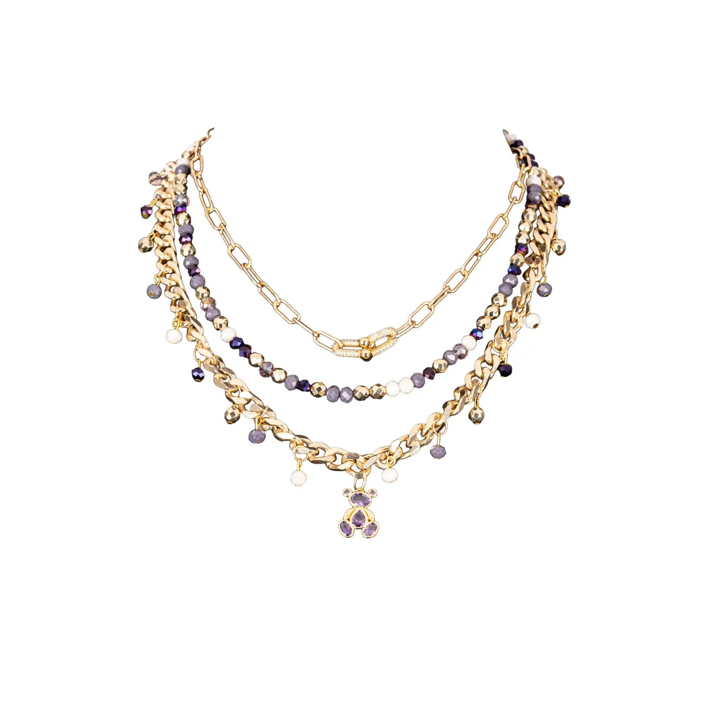 Layered gold necklace with purple crystal beads and small bear charm on white background.