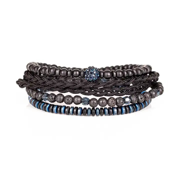 Black and blue multi-layer men’s bracelet featuring braided rope layers, lava stone beads, blue crystal centerpiece bead, faceted crystal accents, and blue metallic disc details on a light background.