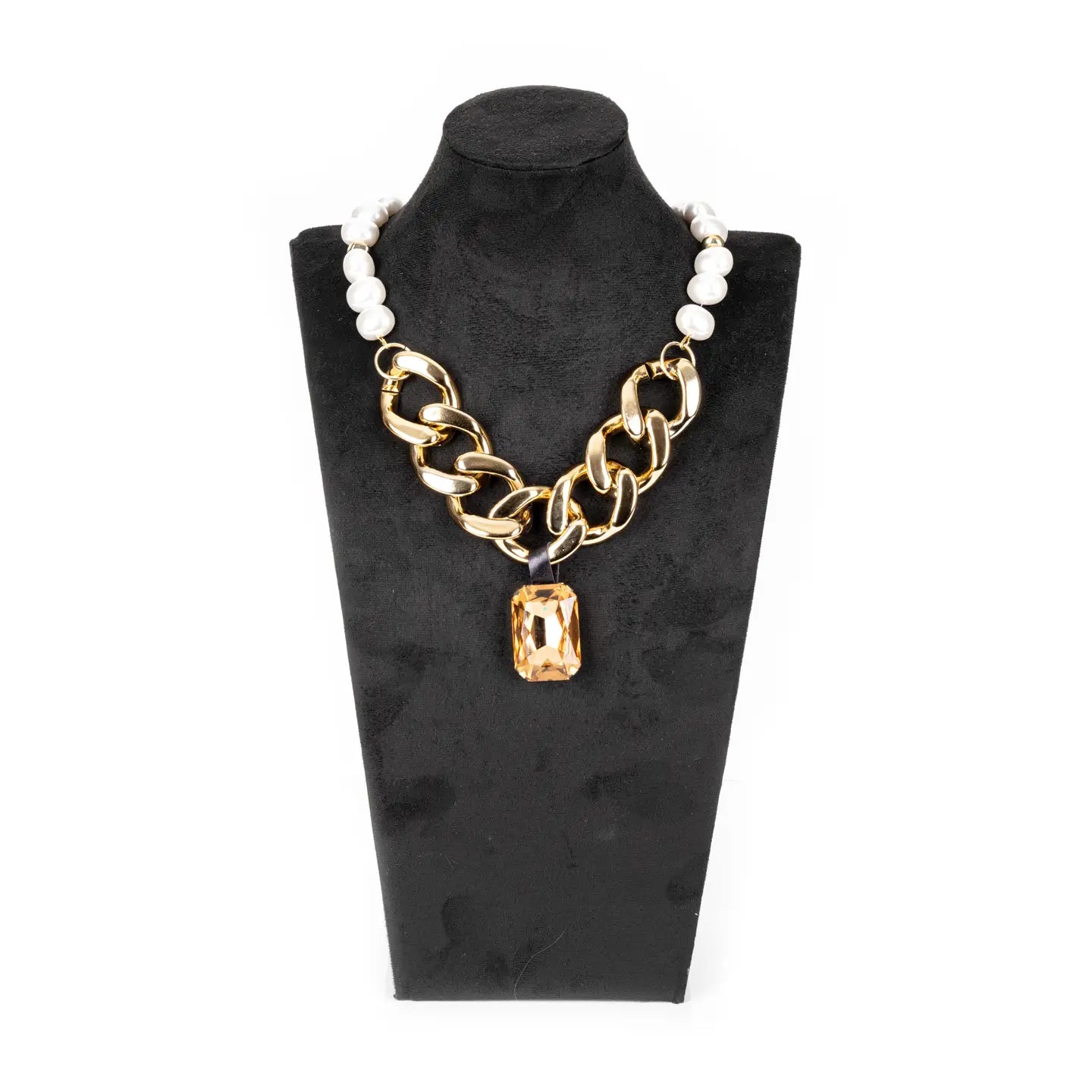 Gold chunky chain necklace with pearl detail and amber crystal pendant on white background.