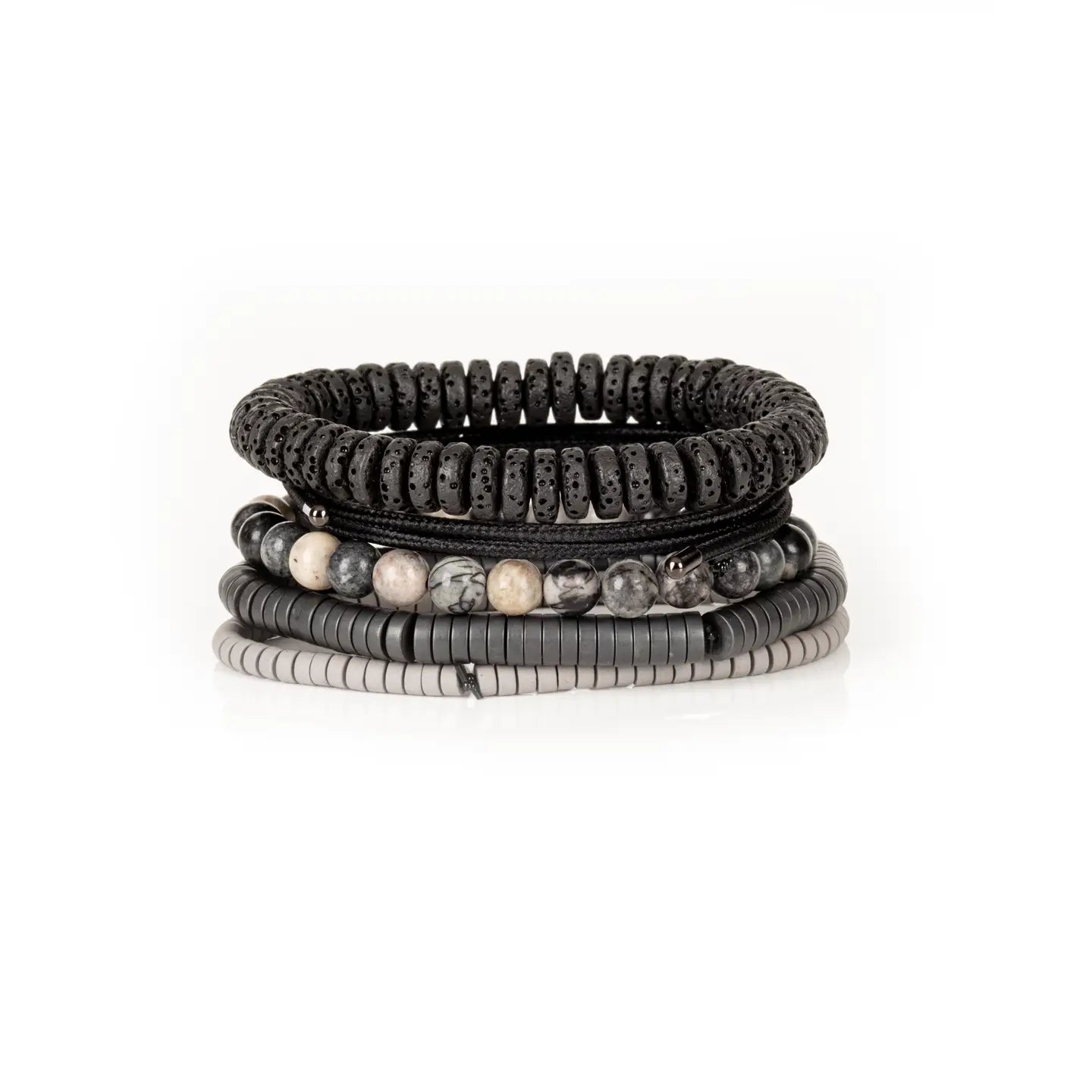 Men’s layered bracelet set featuring black lava stone disc beads, black braided cord wraps, white and gray marbled natural stone beads, black hematite coil beads, and light gray heishi beads, stacked in a sophisticated monochromatic luxury design on a white background.