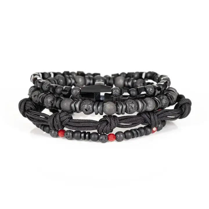 Black multi-layer men’s bracelet set featuring lava stone beads, faceted black onyx, braided rope bands, black cross centerpiece, and subtle red accent beads on a light background.