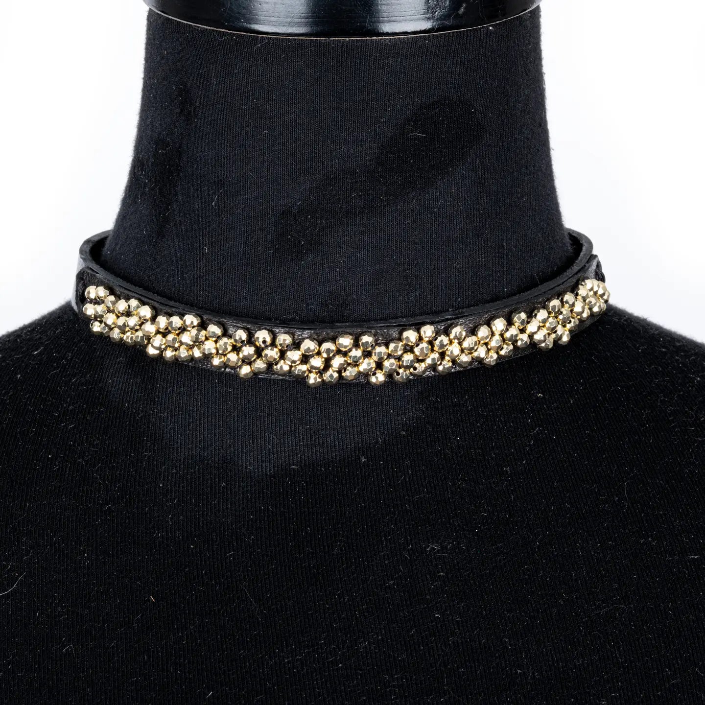 Black leather choker with dense gold beaded detailing across the front, displayed on a white background.