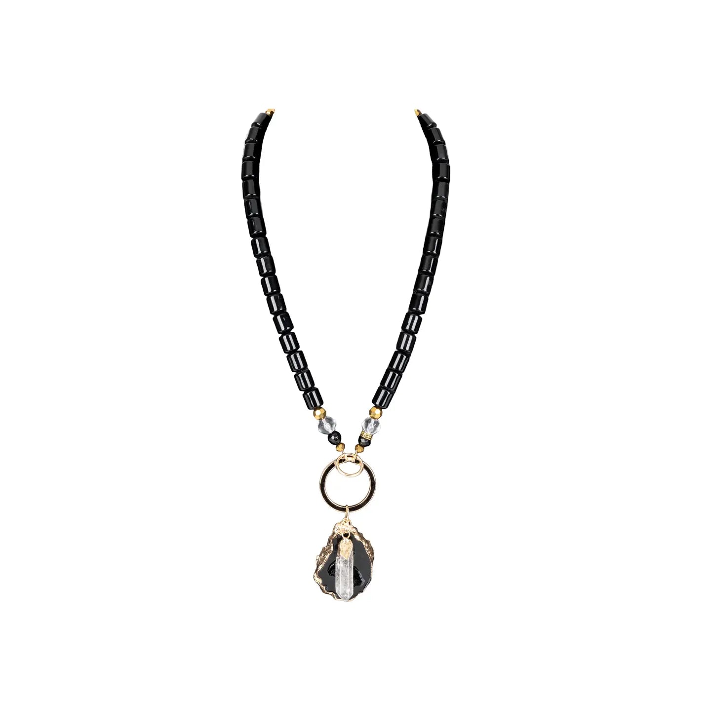 Black beaded necklace with gold ring connector and raw stone crystal pendant on white background.