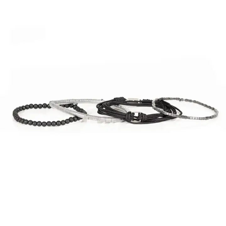 Black and silver layered men’s bracelet set with matte black beads, silver hematite-style spacers, braided rope wraps, and minimalist metallic centerpiece on white background.