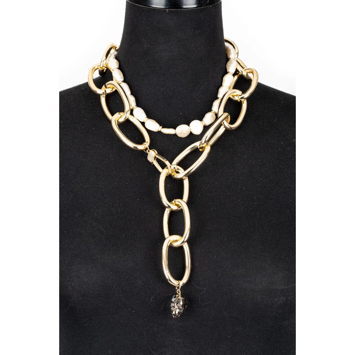 Gold oversized chain necklace with pearl accent and crystal drop pendant on white background.