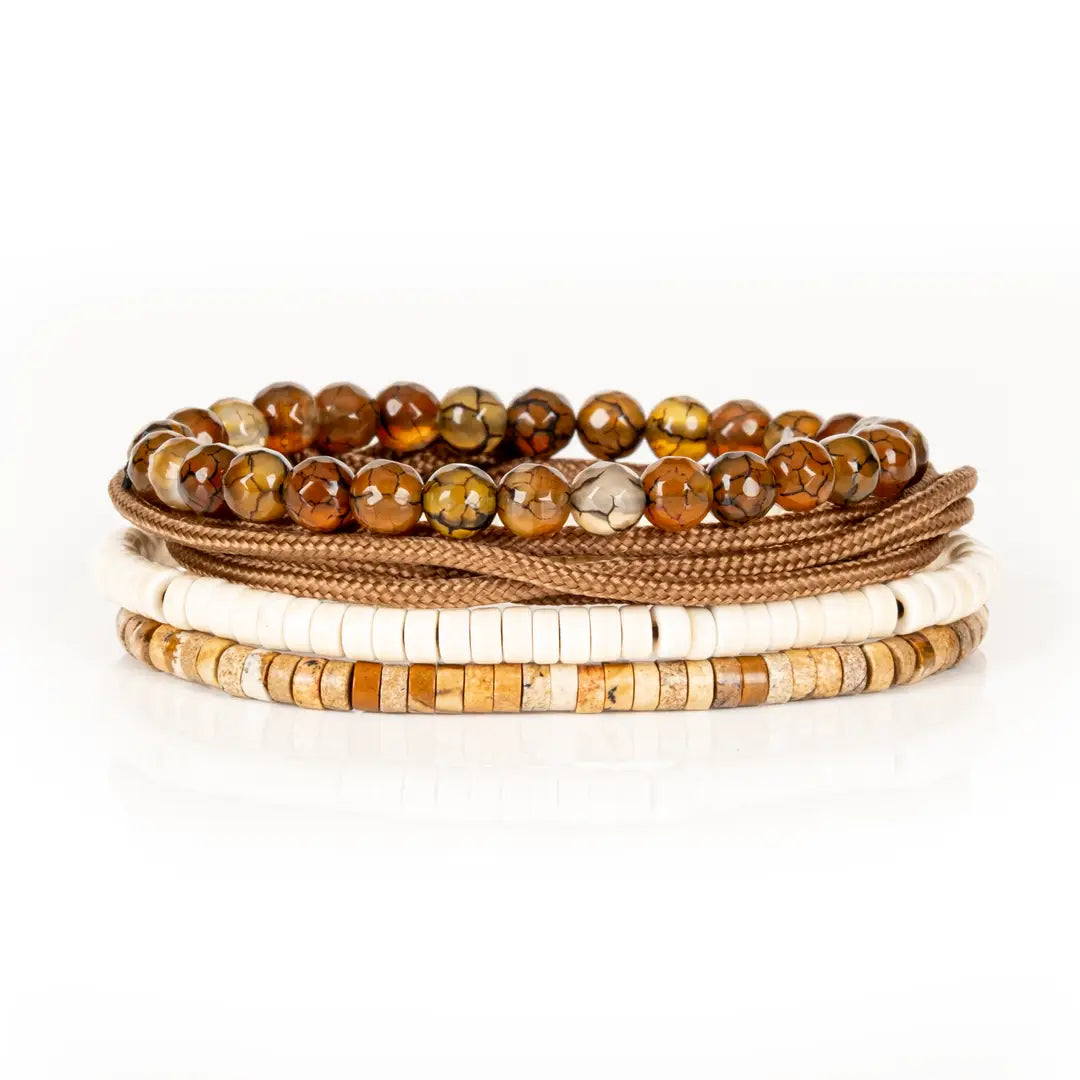 Men’s layered bracelet set featuring faceted brown crackle agate beads, tan braided cord wraps, white heishi beads, and natural earth-tone stone disc beads, stacked in a refined bohemian luxury
design on a white background.