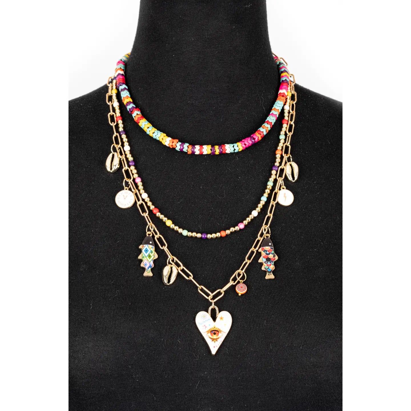 Colorful layered necklace with multicolor beads, gold chains and evil eye heart pendant on white background.