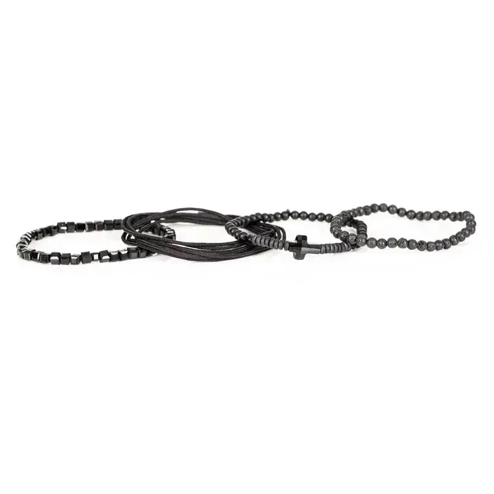 Black layered men’s bracelet set with lava stone beads, geometric crystal cube accents, matte black beads, polished centerpiece, and braided rope wraps on white background.