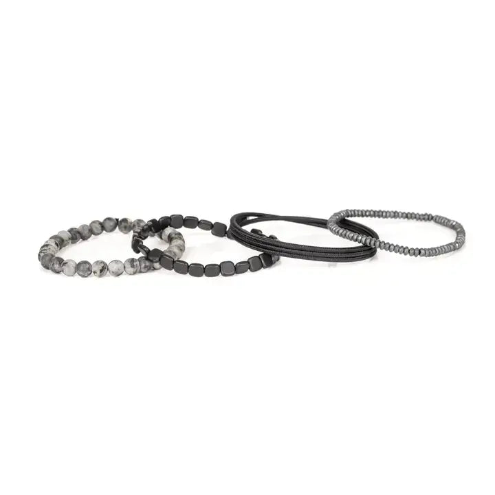 Men’s layered bracelet set featuring gray marbled natural stone beads, polished black hematite cube beads, black braided cord wraps, and silver-gray heishi beads, stacked in a sleek monochromatic luxury design on a white background