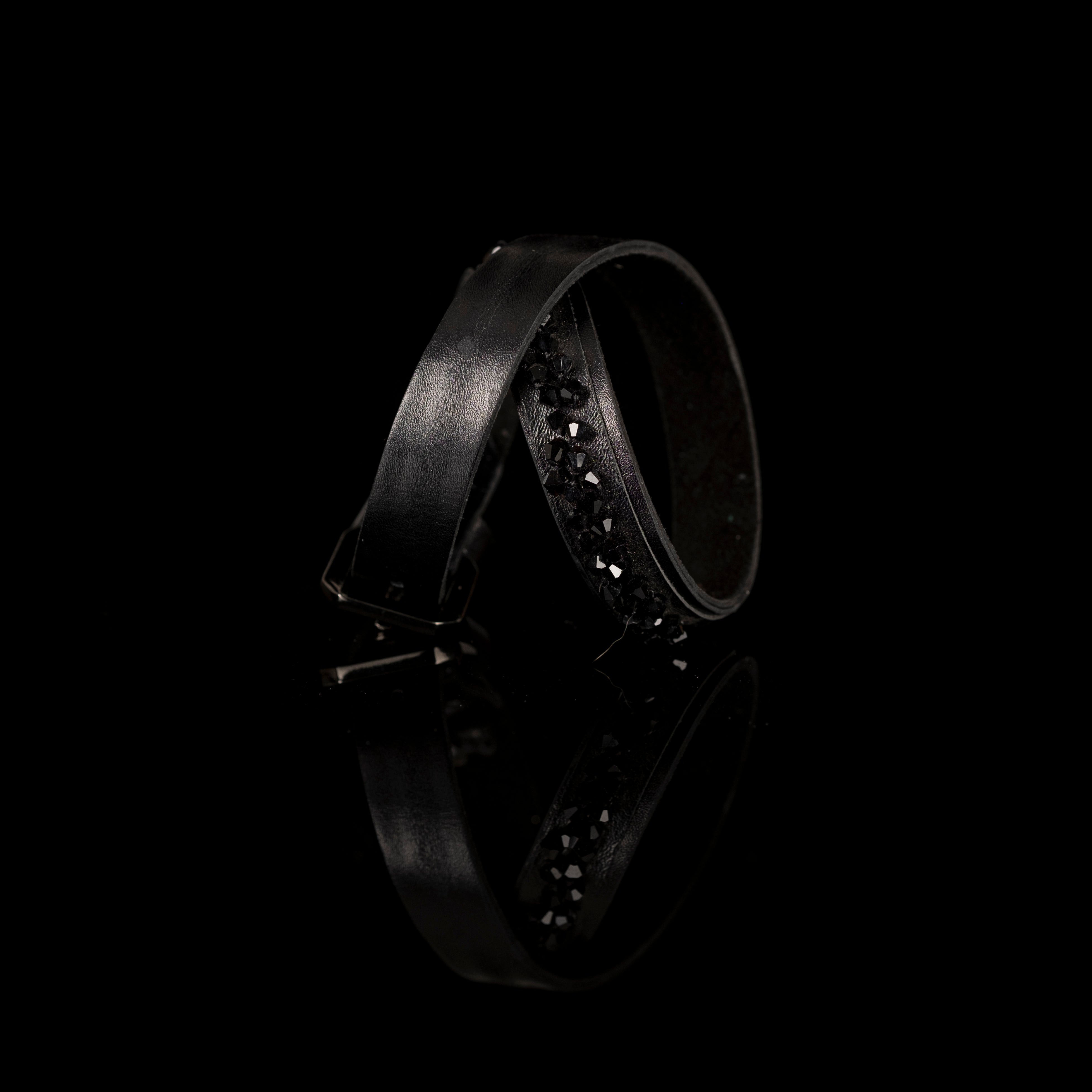Minimalist black leather bracelet with faceted black crystal edge and buckle closure, handmade by THE DARK