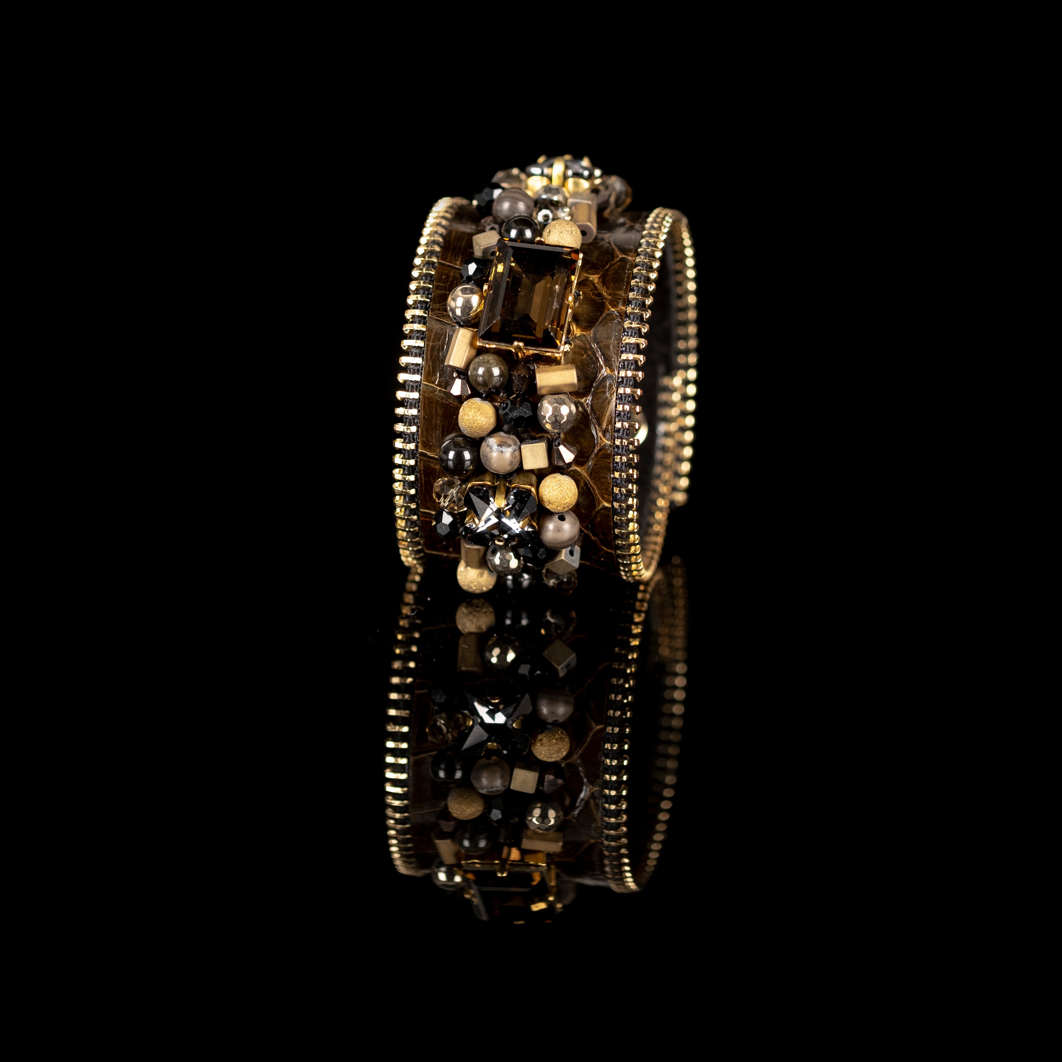 Brown python leather cuff bracelet with smoky crystal centerpiece and gold black bead embellishments, handmade statement bracelet by THE DARK