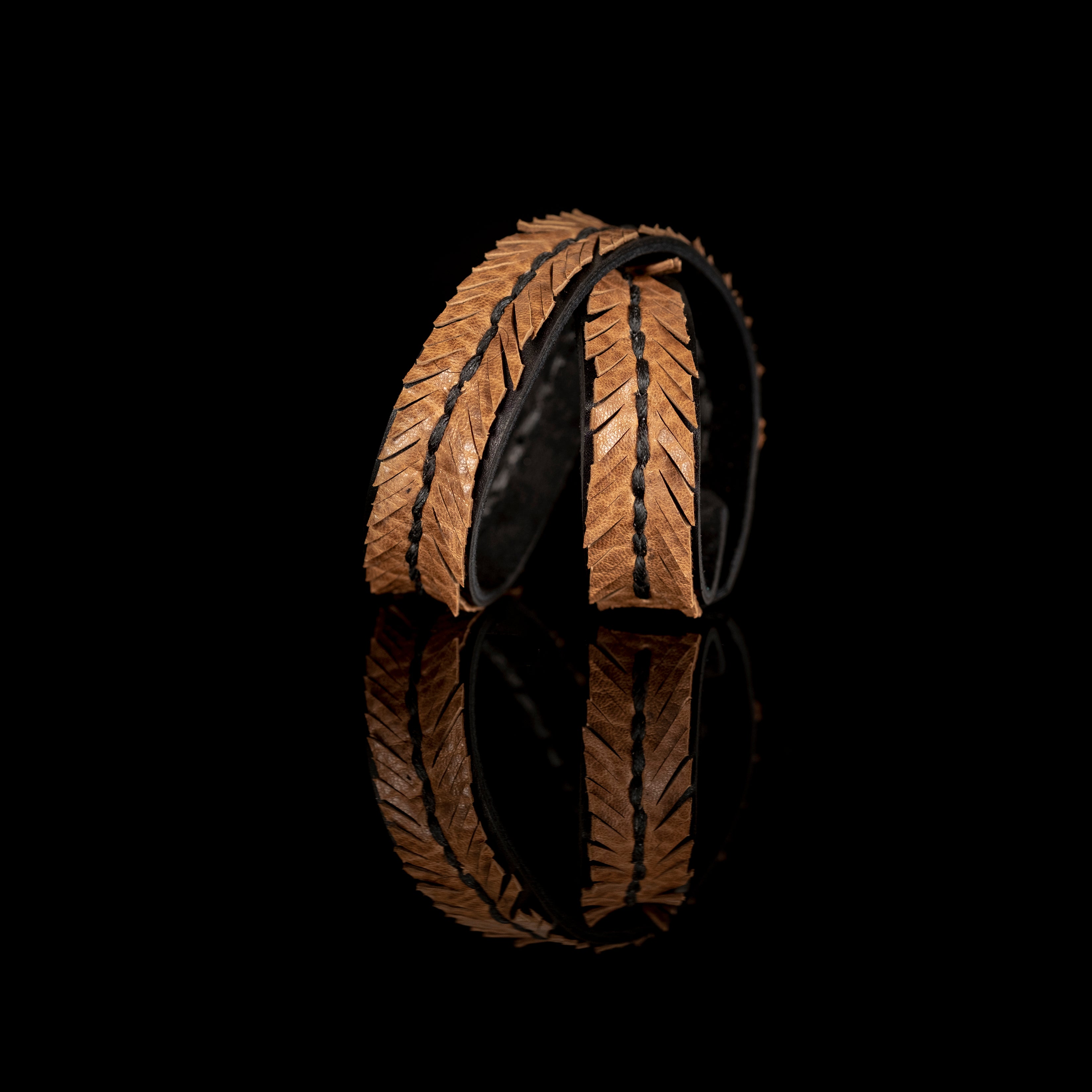 Tan leather wrap bracelet with feather textured pattern and braided center detail, handmade bracelet by THE DARK