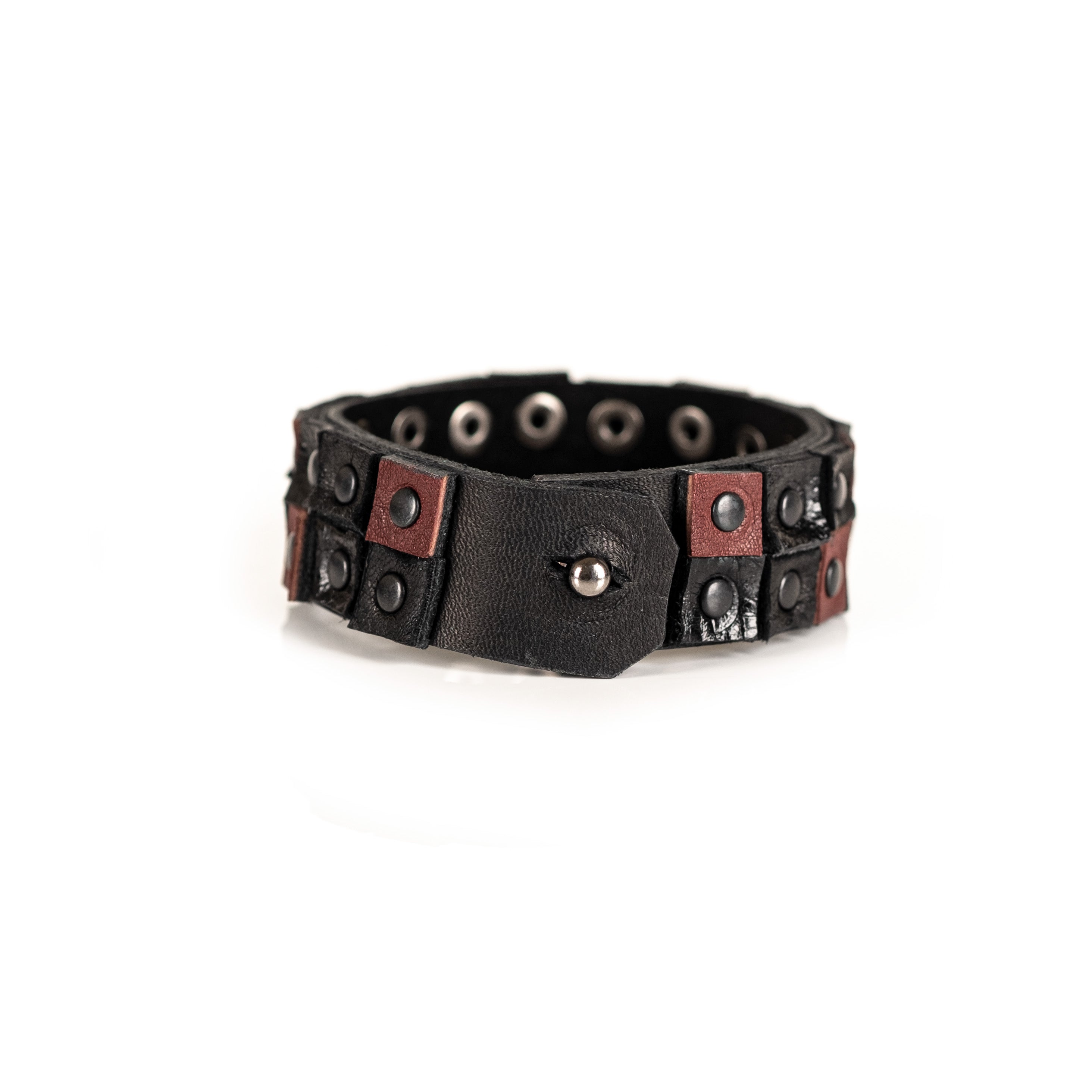 Men's black and brown leather cuff bracelet featuring a double-row studded design with gunmetal rivets and handcrafted leather panels.