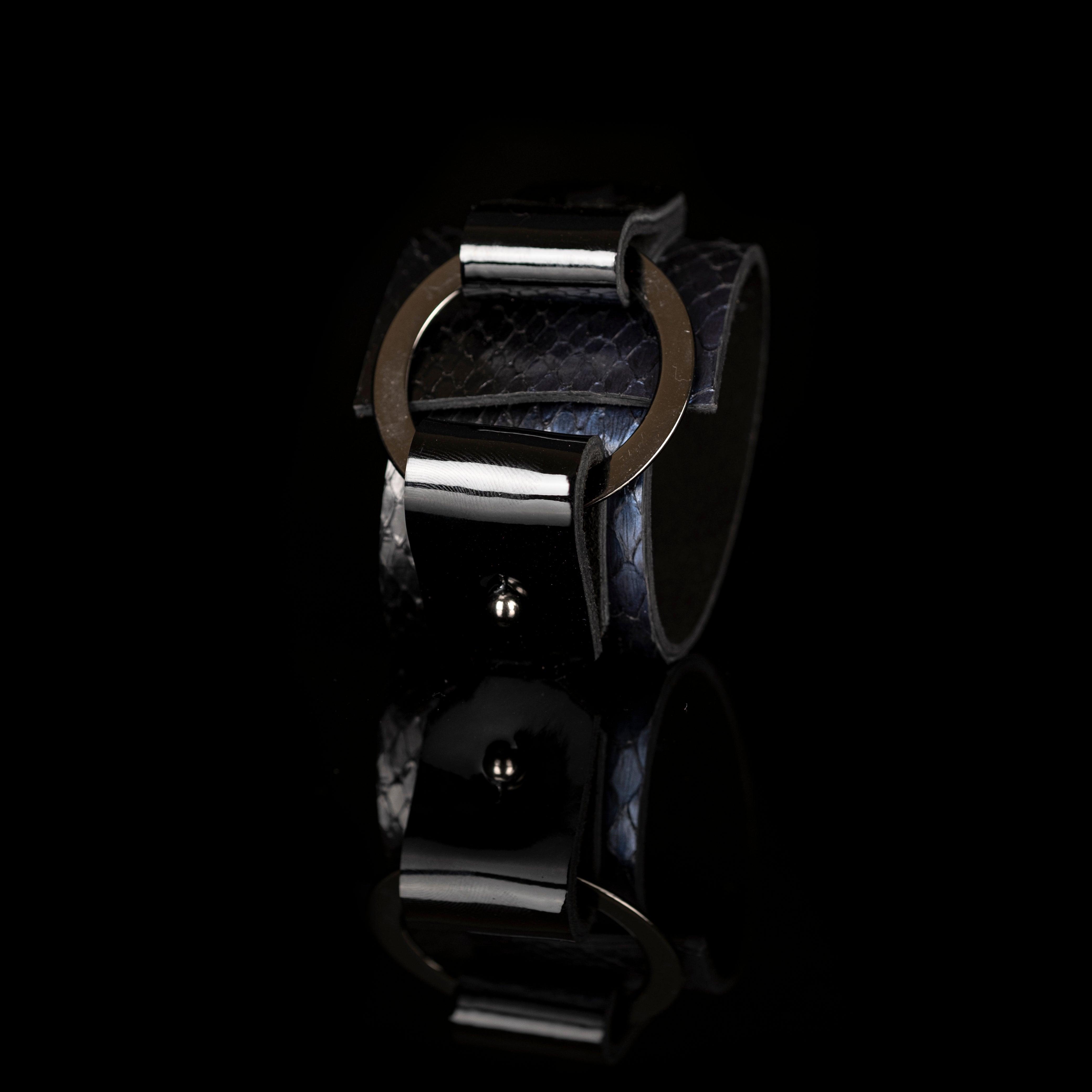 Black python leather cuff bracelet with metal halo ring and glossy leather straps, handmade statement cuff by THE DARK