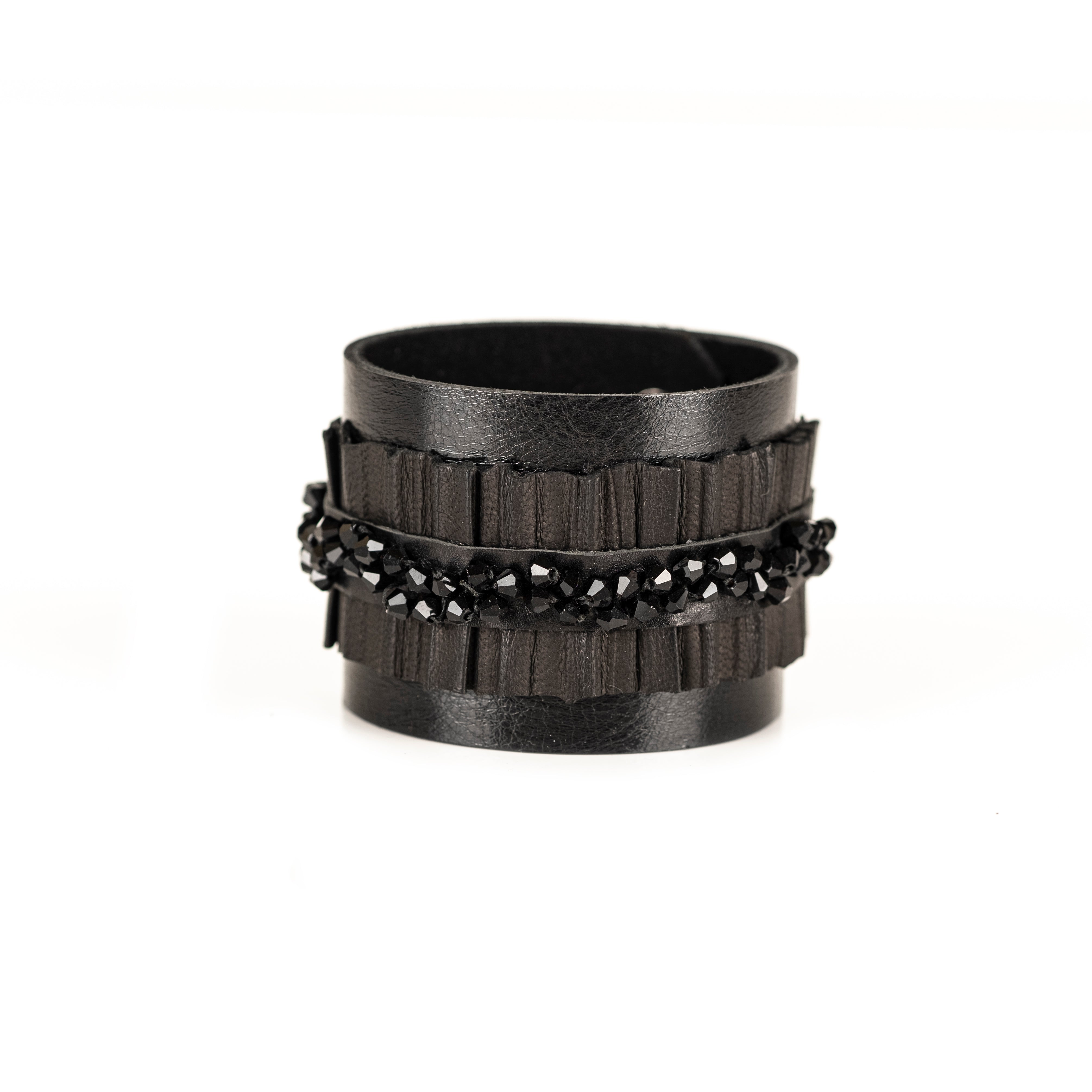 Black leather cuff bracelet with central faceted black crystal band and textured leather layers, handmade statement bracelet by THE DARK