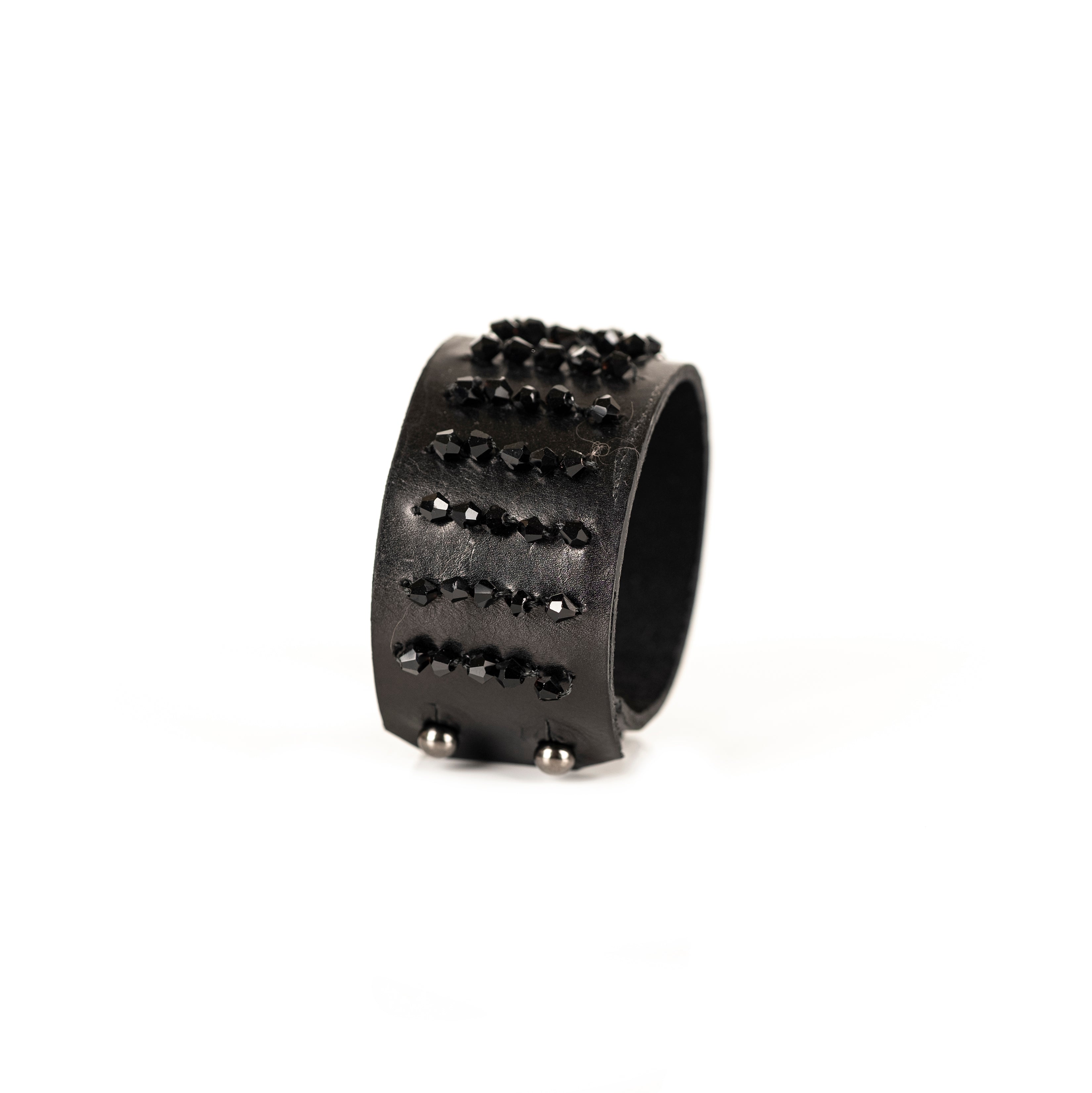Black leather cuff bracelet with horizontal rows of faceted black crystals and metallic beads, handmade statement bracelet by THE DARK