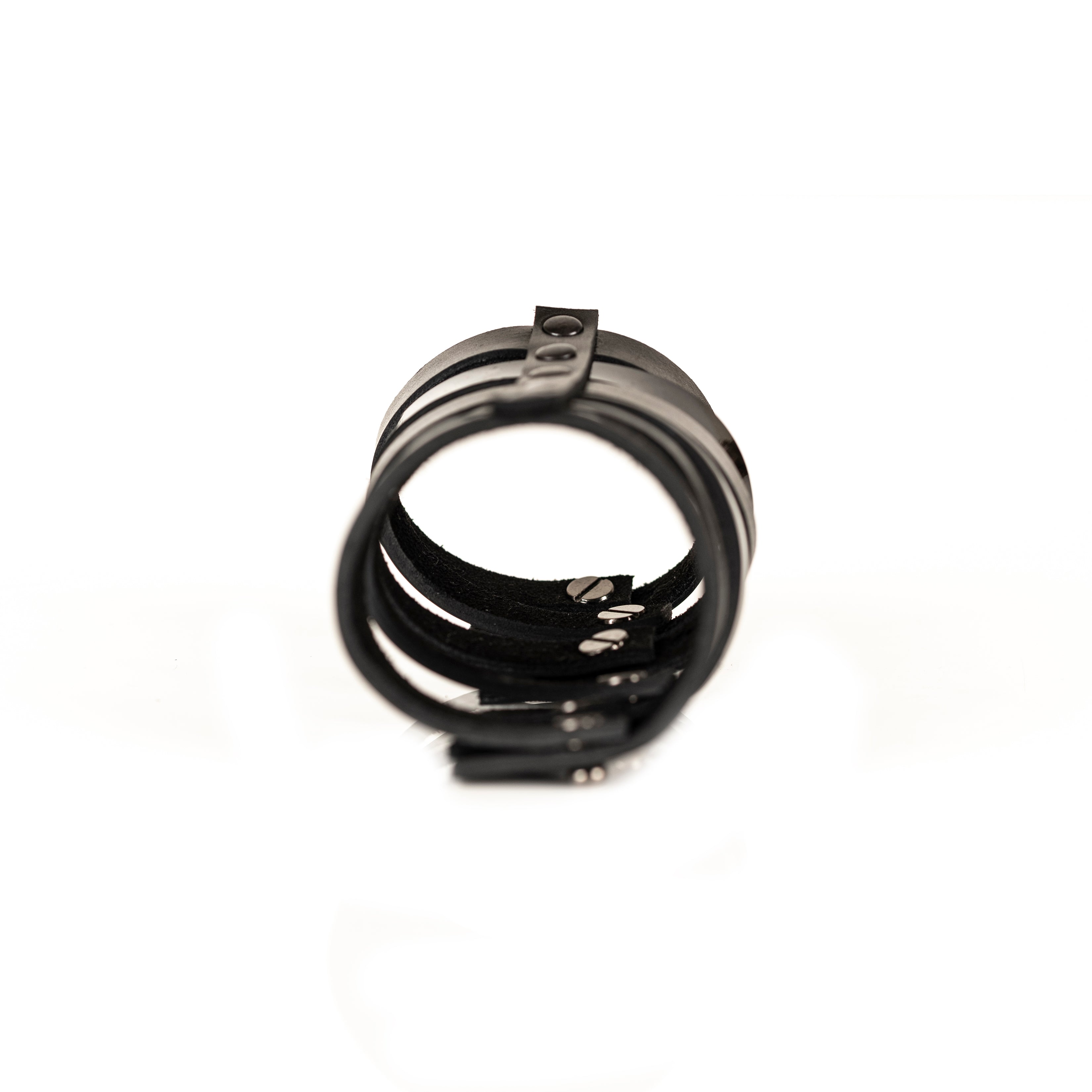 Black leather fringe bracelet with multiple hanging leather straps, handmade sculptural statement cuff by THE DARK
