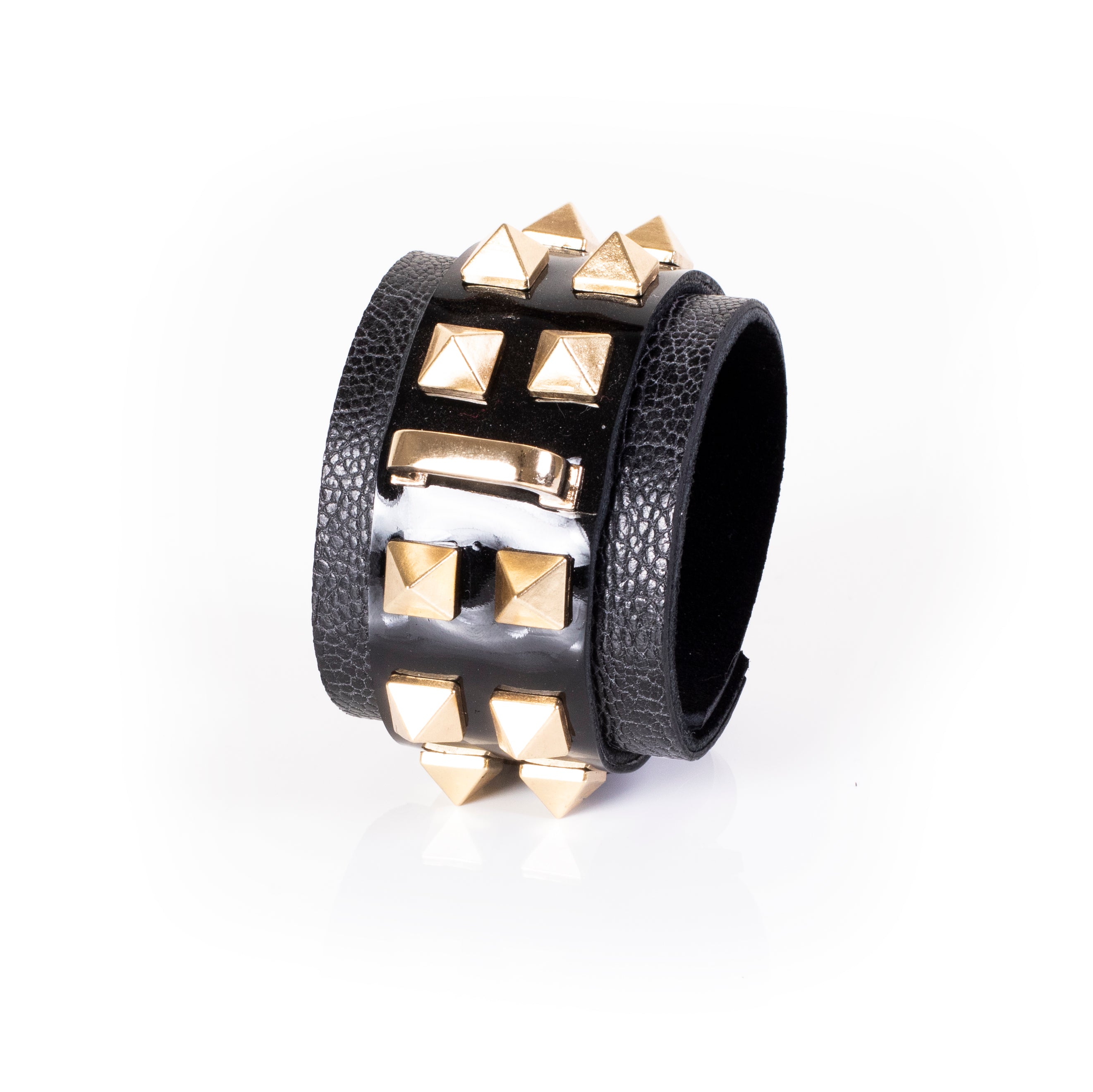 Black patent leather cuff bracelet with gold pyramid studs and textured leather side panels, wide handcrafted statement bracelet for women by THE DARK