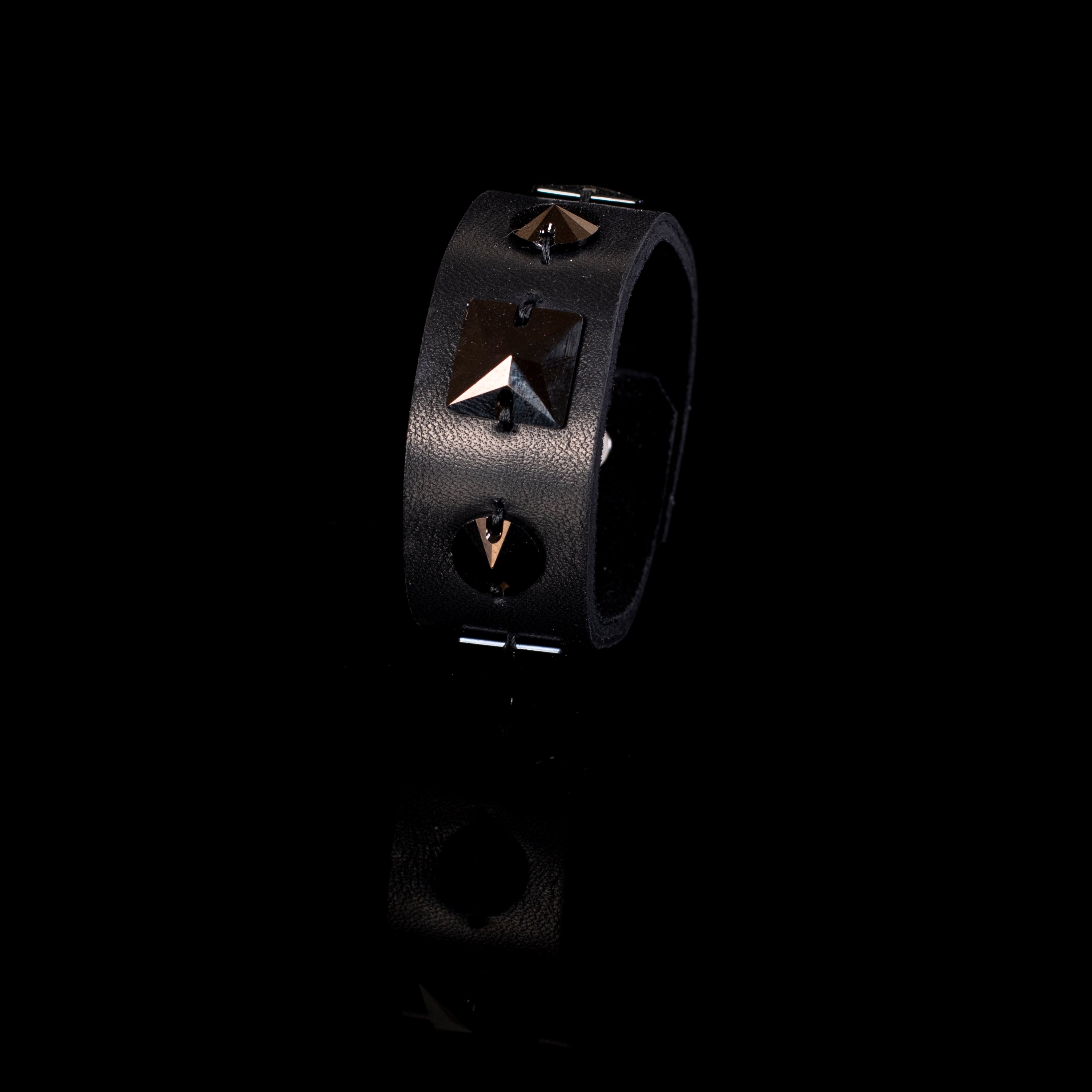 Black leather cuff bracelet with geometric metal studs and pyramid detail, handcrafted wide statement bracelet for women