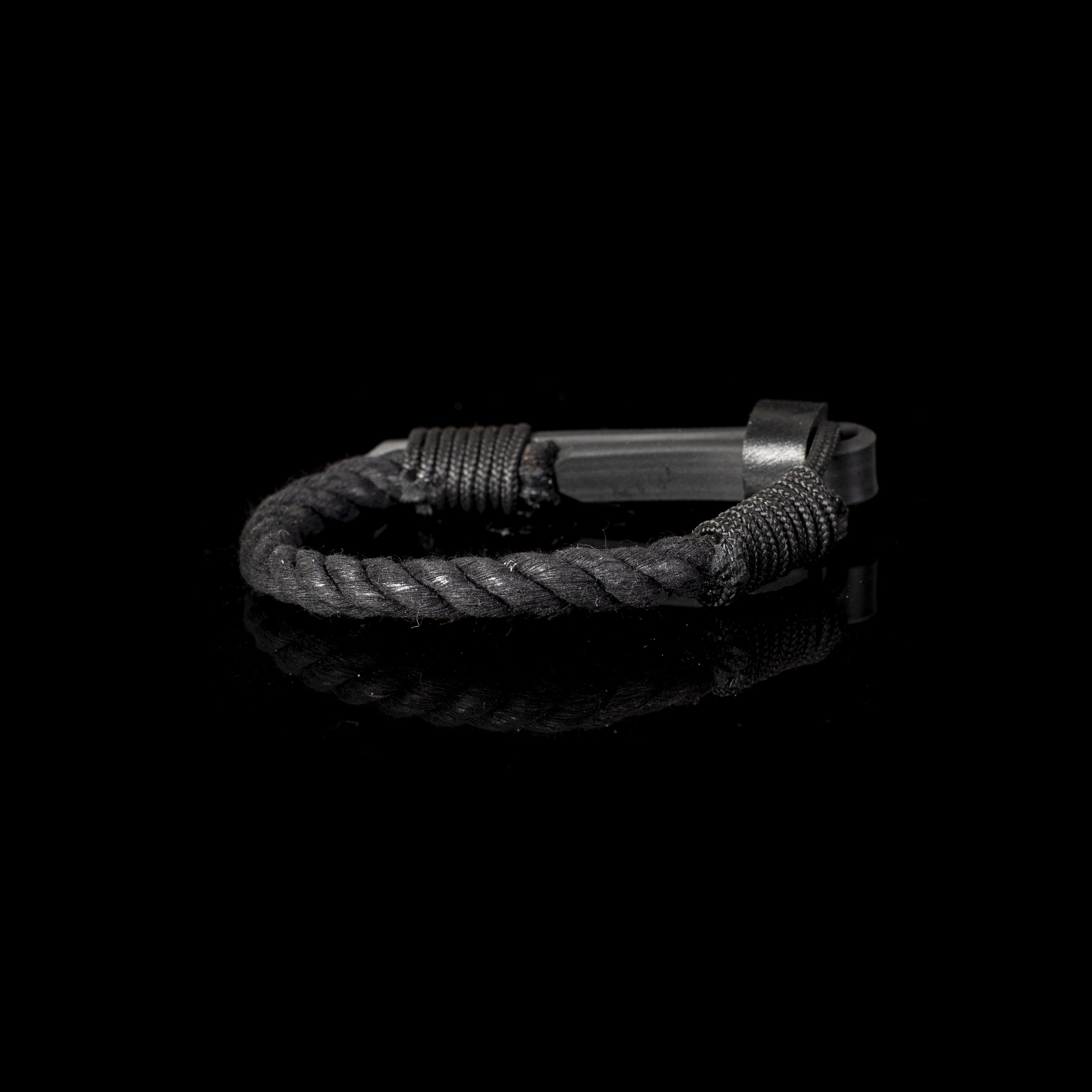 Handmade black braided leather bracelet for men featuring a black leather hook closure and thick braided leather design on a white background.