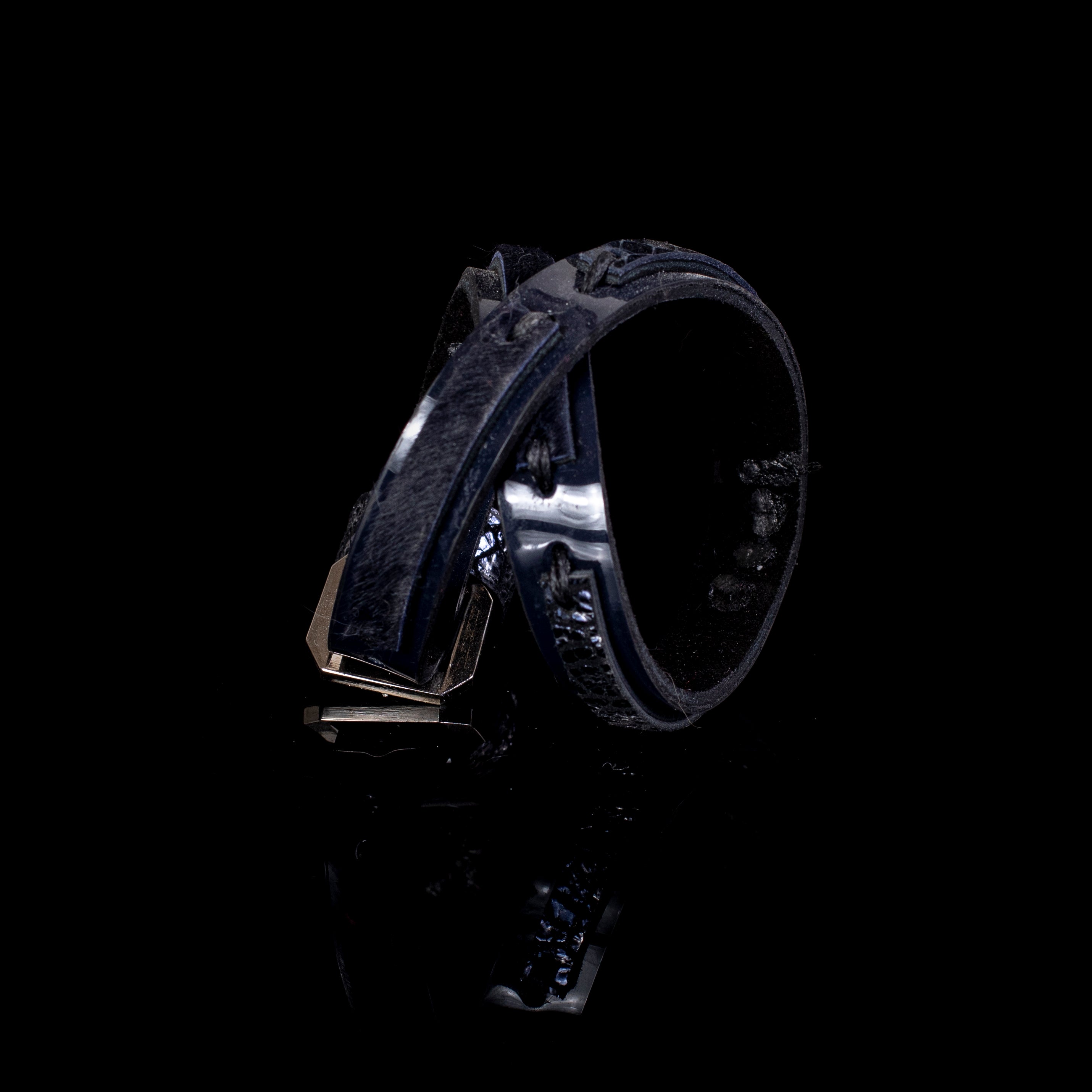 Black leather sculptural cuff bracelet with layered construction and minimal architectural design, handcrafted statement bracelet for women by THE DARK