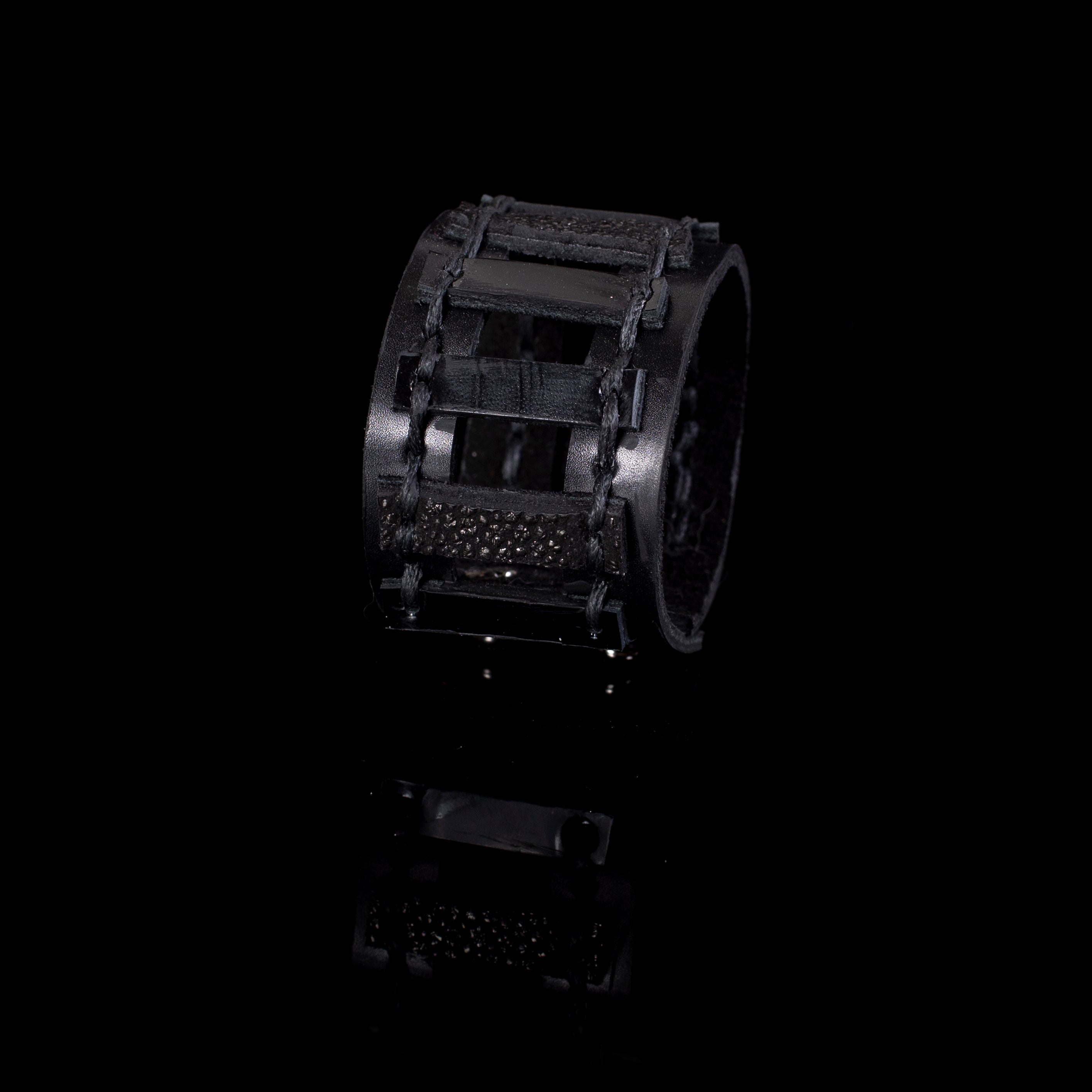 Black leather cuff bracelet with cage structure and textured strips, wide statement bracelet for women