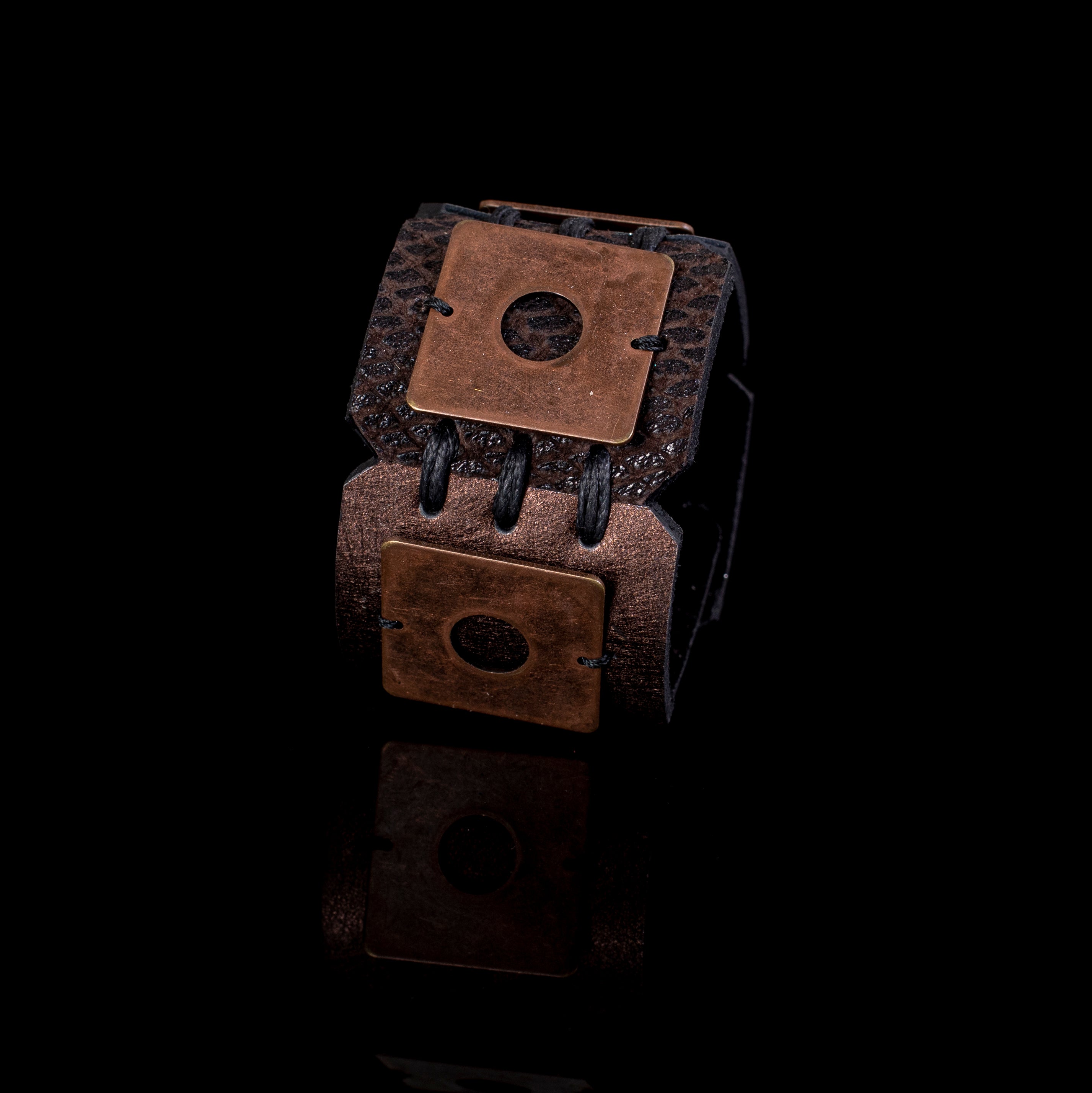 Black leather cuff bracelet with copper square plates and circular cutouts, handcrafted industrial statement bracelet for women
