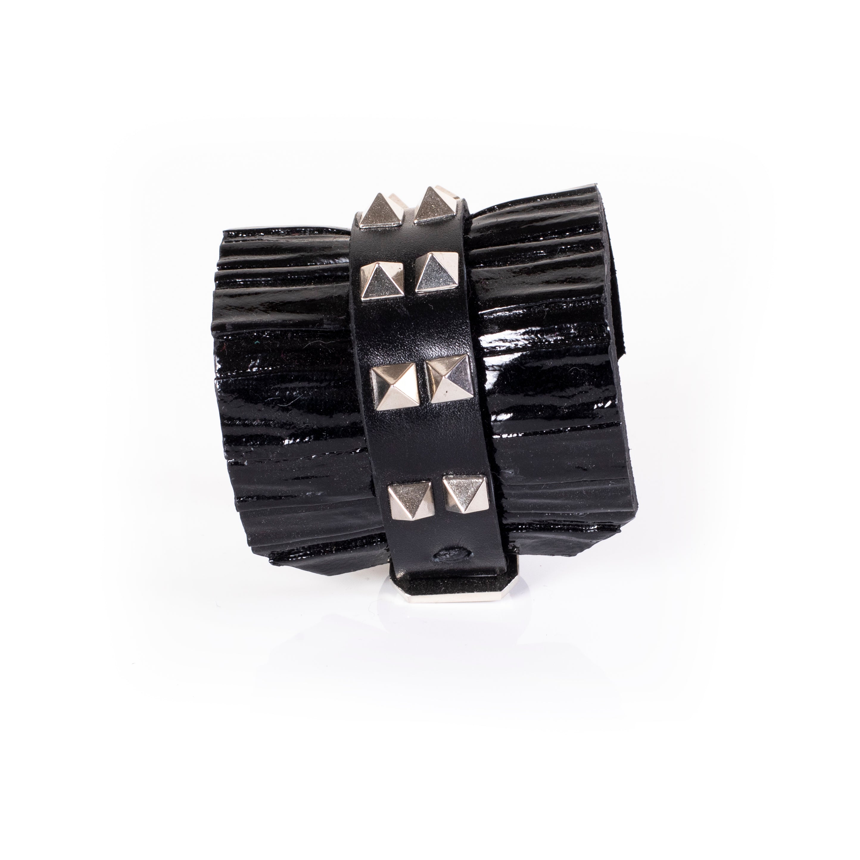 Black patent leather cuff bracelet with central studded leather band and glossy textured surface, wide handcrafted statement bracelet for women by THE DARK