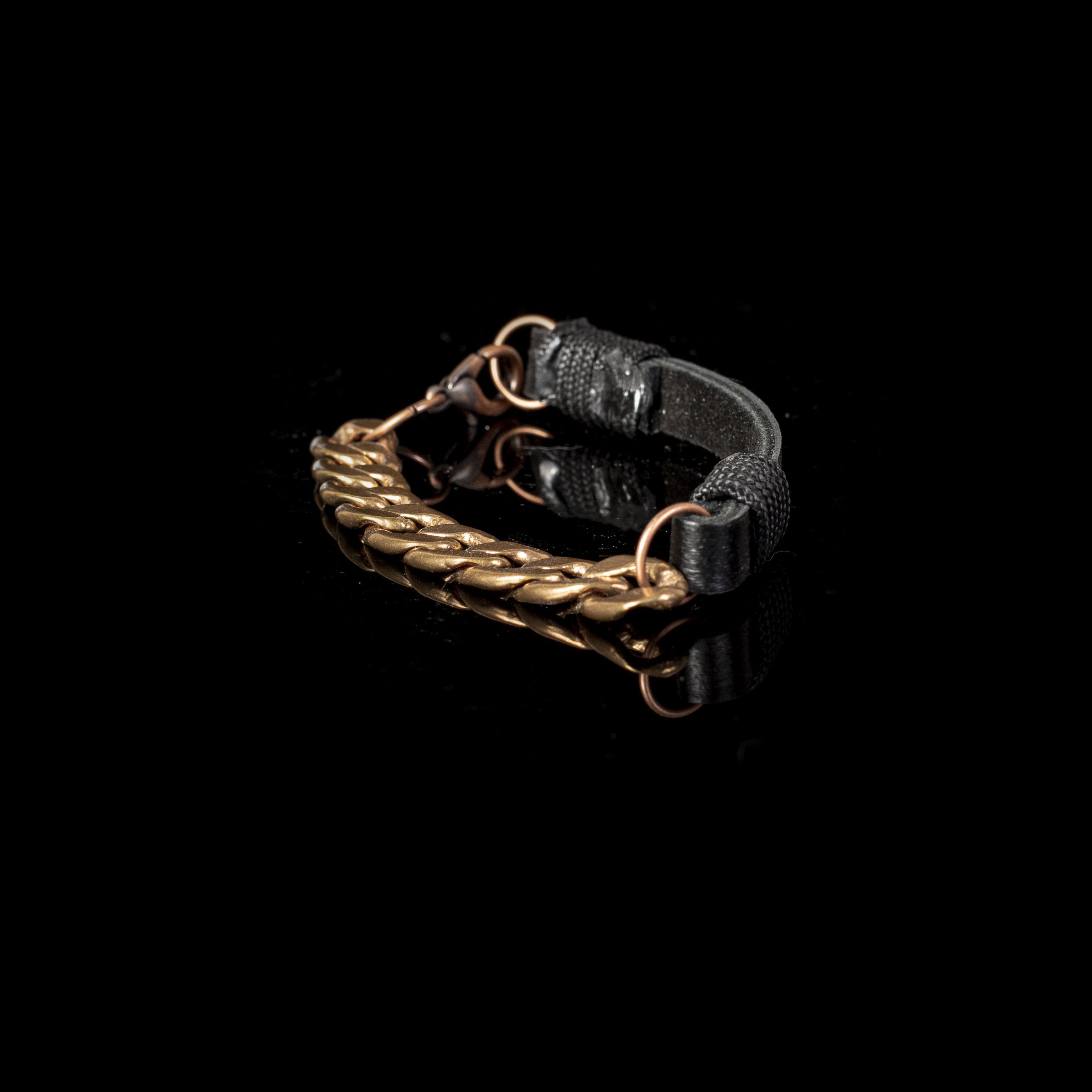 Handmade black leather bracelet featuring an antique gold-tone curb chain and adjustable clasp in an industrial-inspired design.